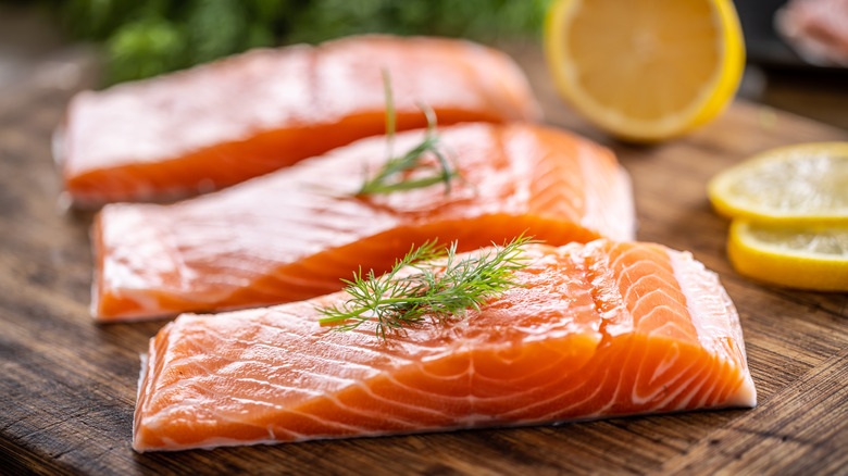 Salmon fillets on cutting board with lemon